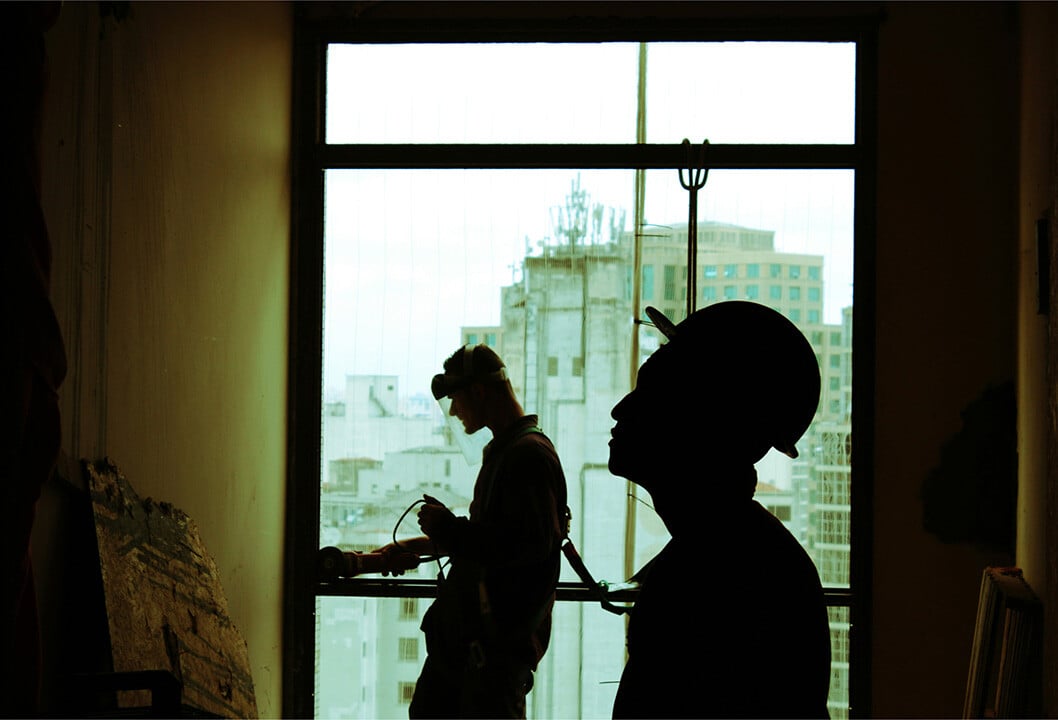 Silhouette of two builders