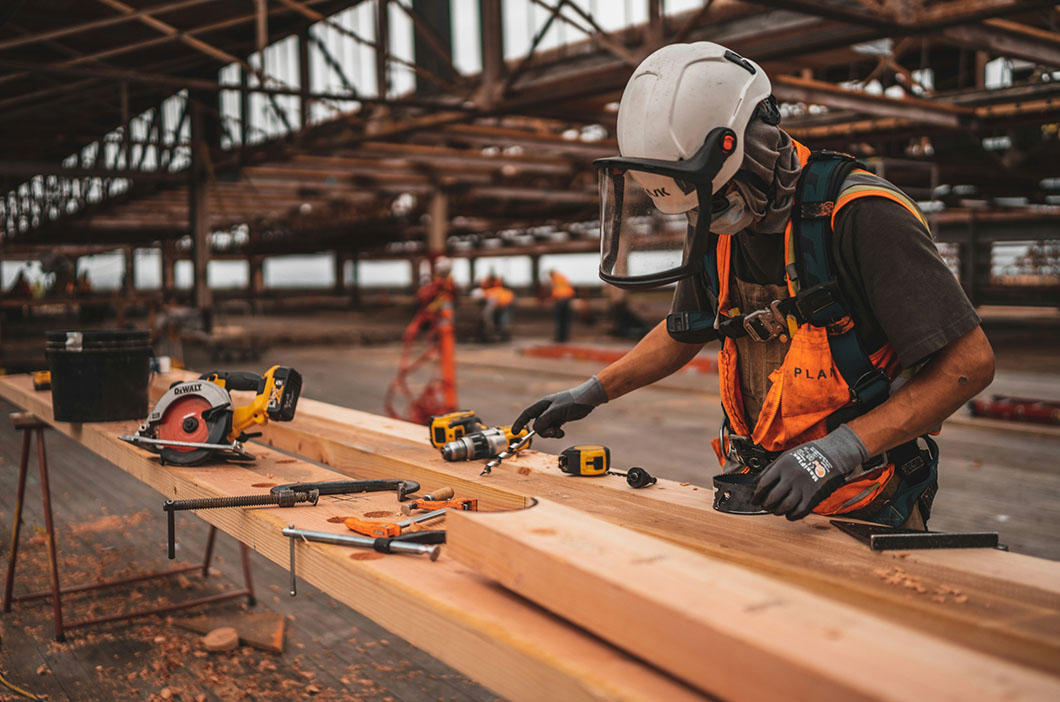 EHS lone worker cutting wood empty factory
