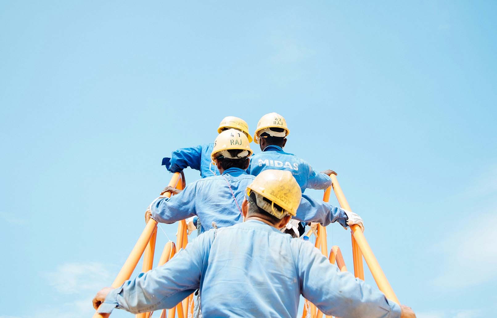 Multiple workers external staircase yellow and blue