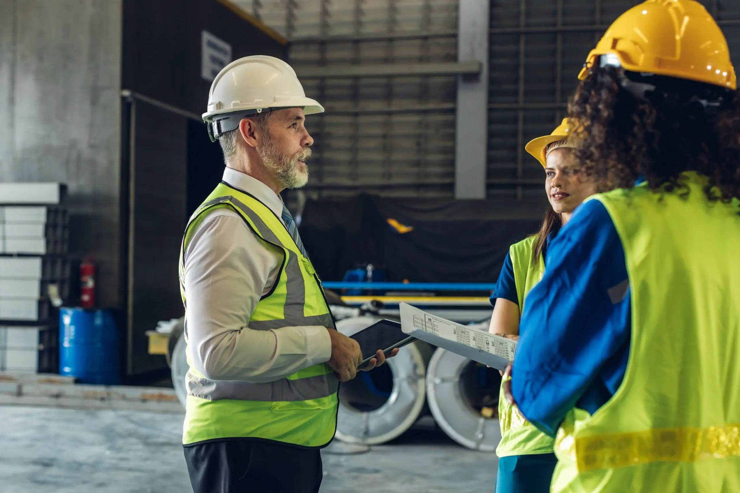 Three workers discussing health and safety