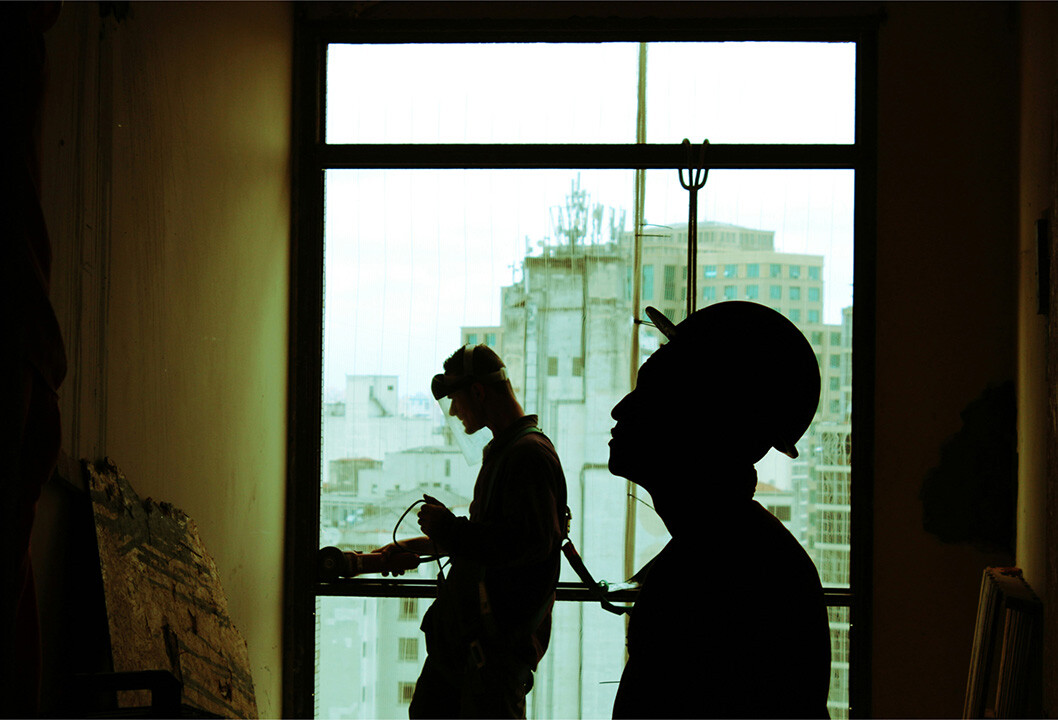 Silhouette of two builders